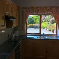 View of the garden and seating area looking out of the kitchen window at Drainbyrion Farm Self Catering.