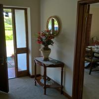 Accommodation hallway showing front door, also doors to Dining Room, Kitchen, and Lounge.